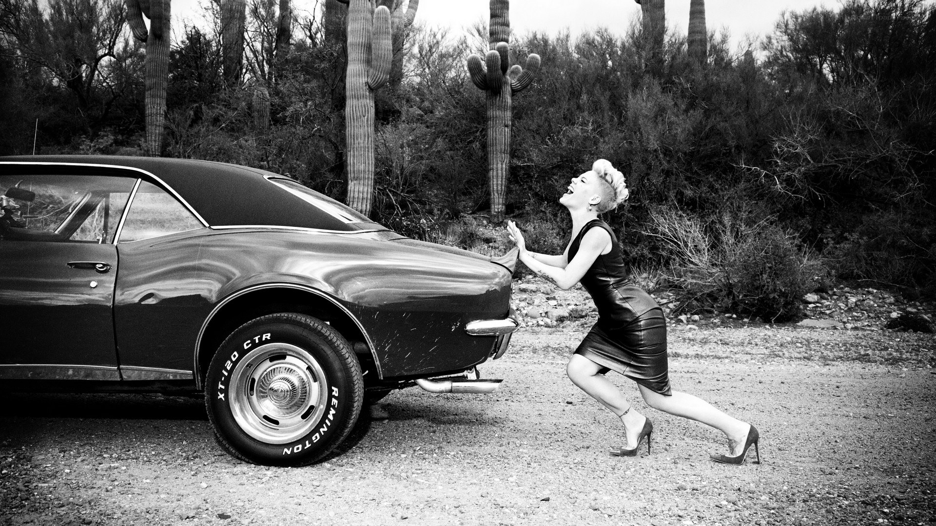 woman pushing classic car