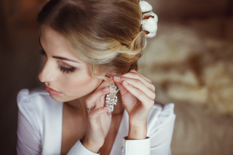 Woman Putting on Earring
