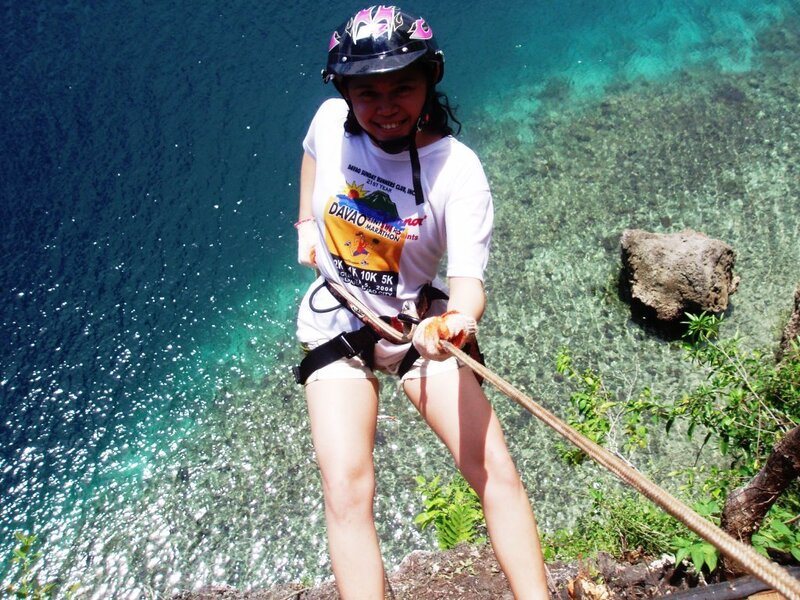 Woman Rappelling on Cliff