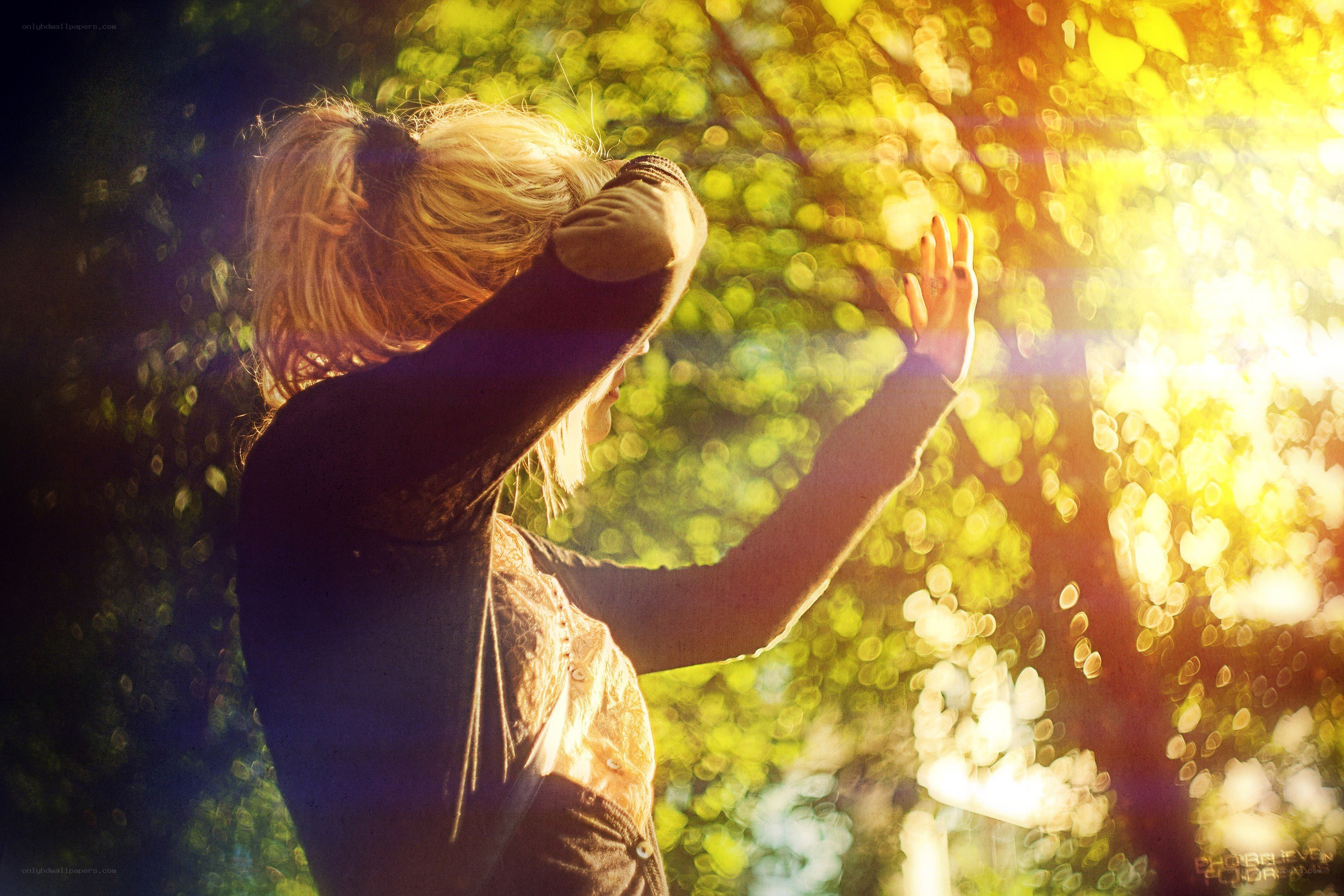 woman reaching for sunlight