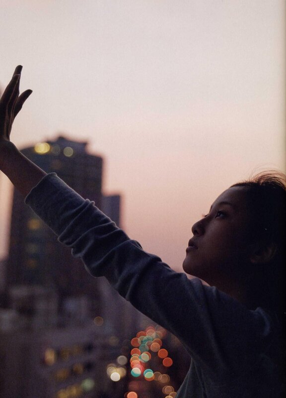 woman reaching toward the sky
