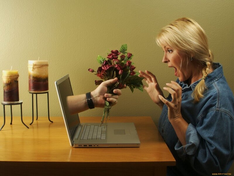 Woman reacts to flowers from laptop