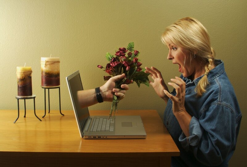 woman reacts to flowers from laptop