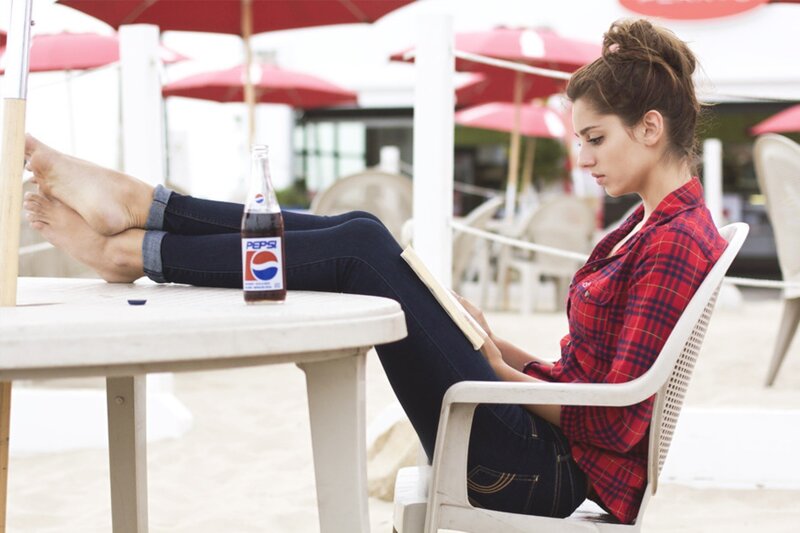 Woman reading at beach cafe