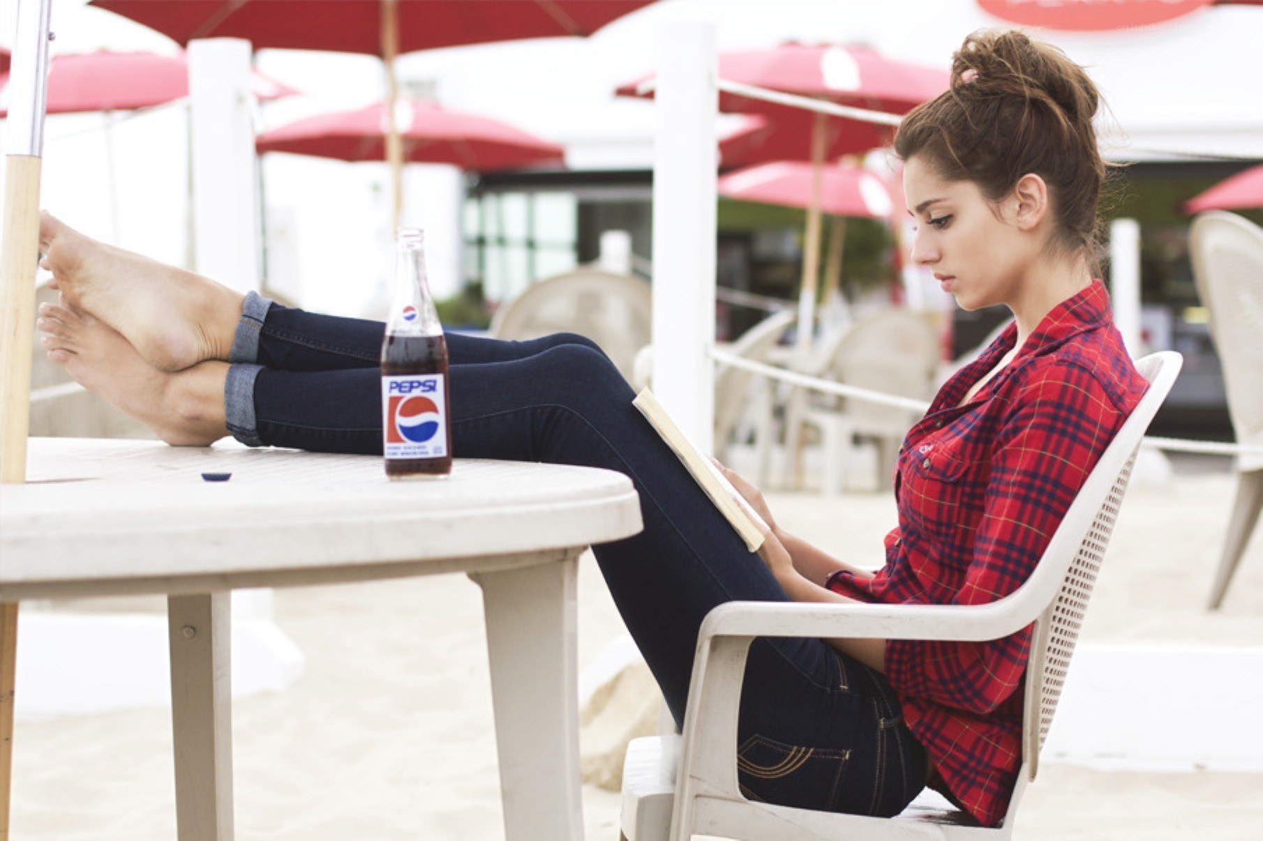 Woman reading at beach cafe