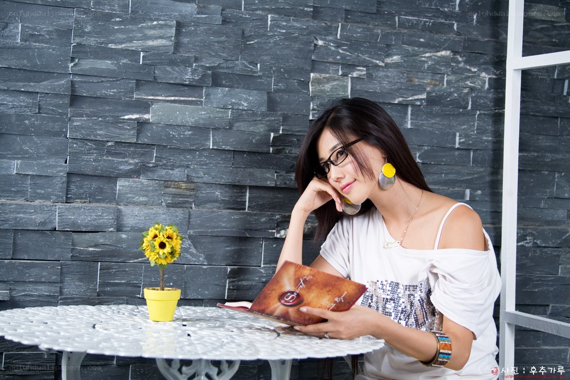 woman reading book at table