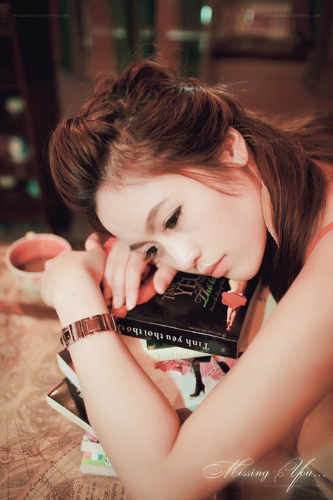woman reading book at table