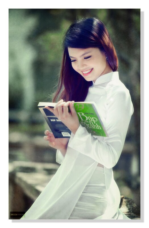 Woman reading book in ao dai