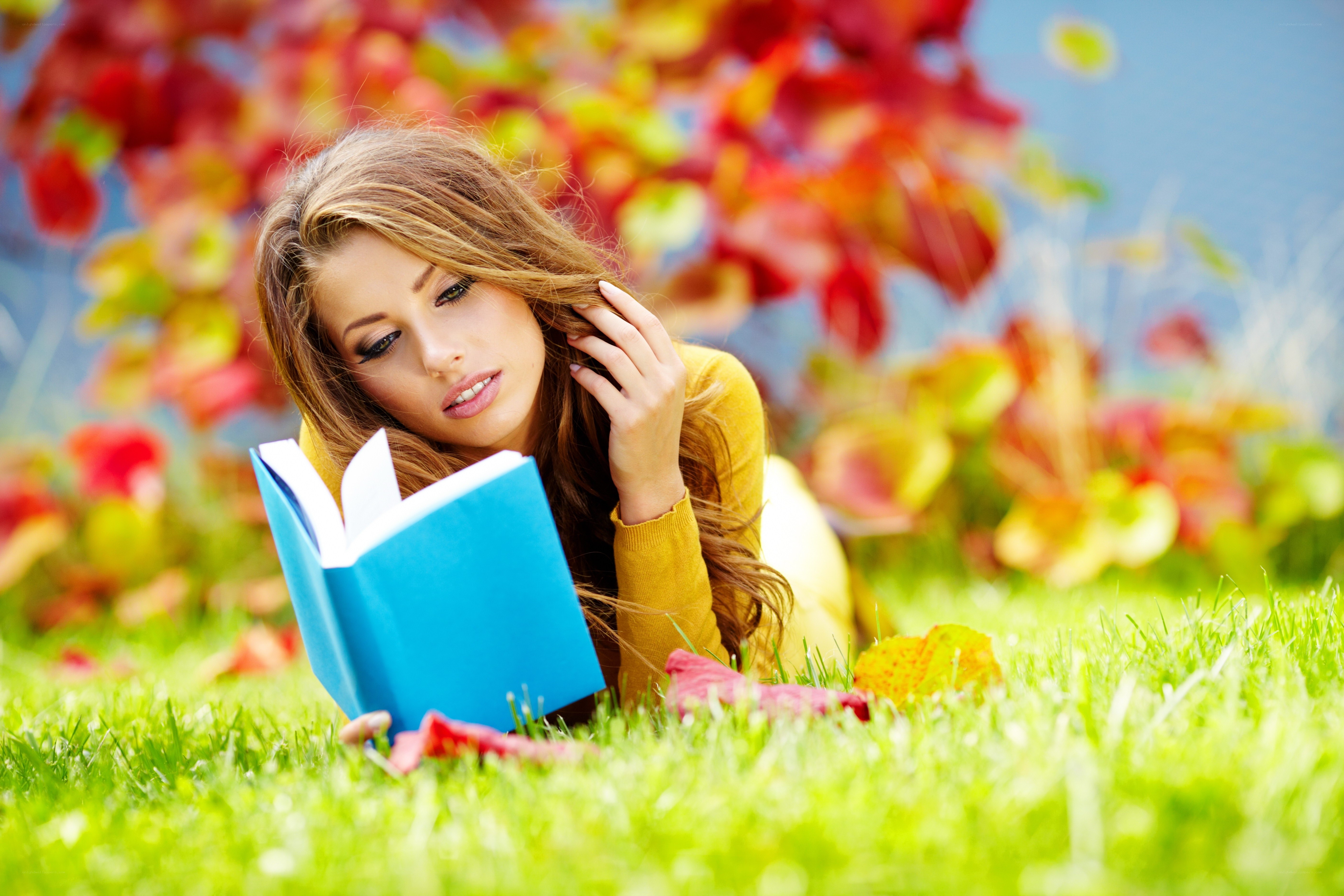 Woman reading book in autumn