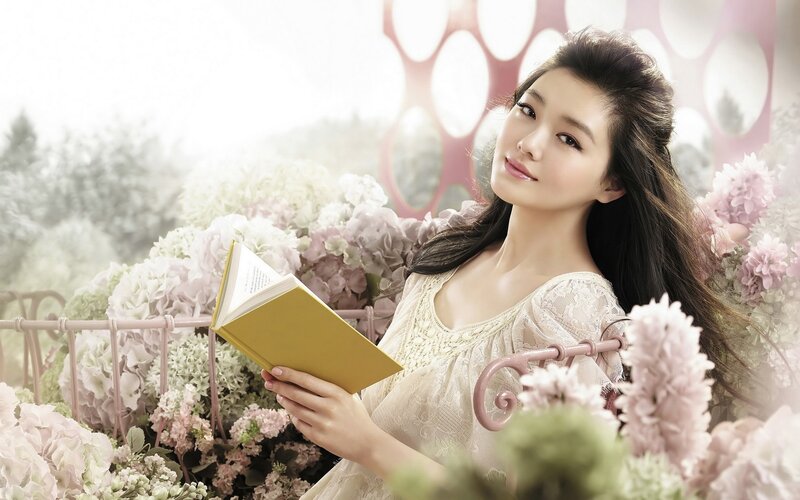 woman reading book in garden
