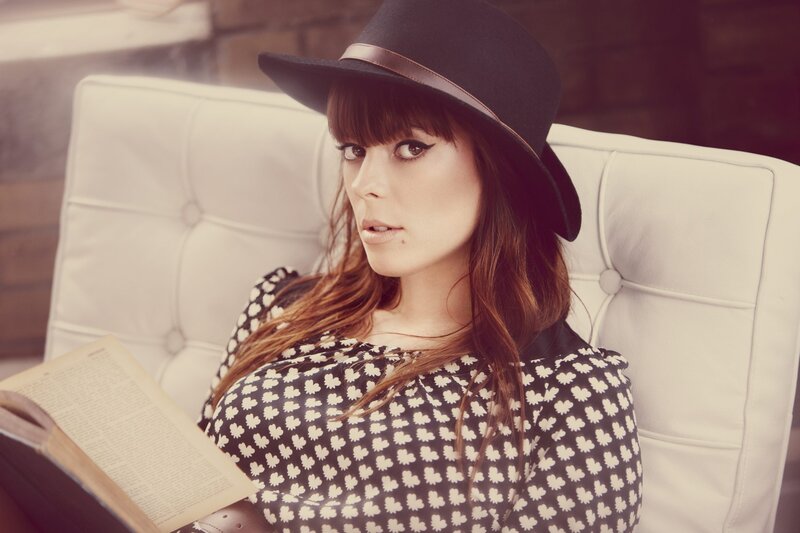woman reading book in hat