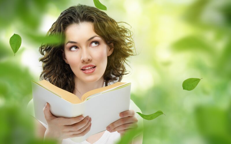woman reading book in nature