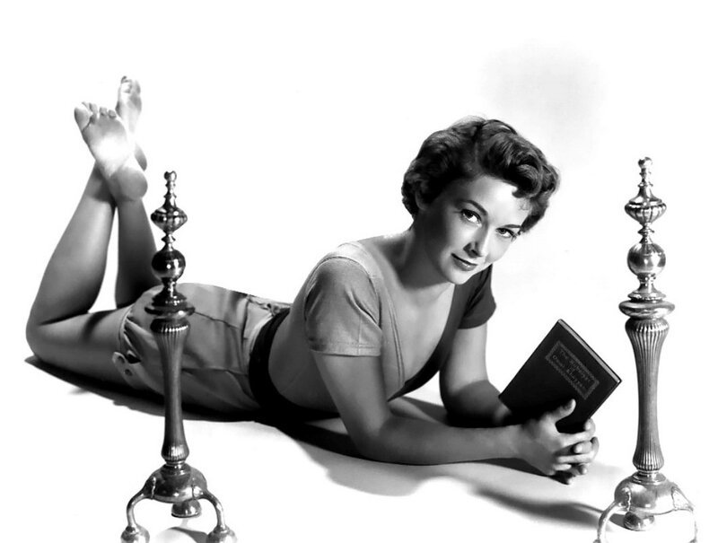 woman reading book on floor