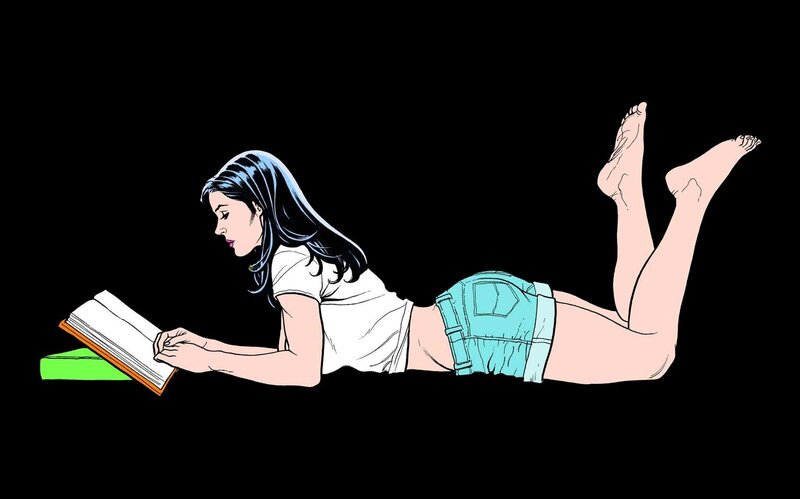 woman reading book on stomach