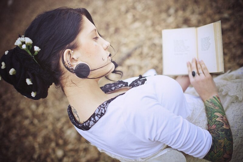 woman reading book outdoors