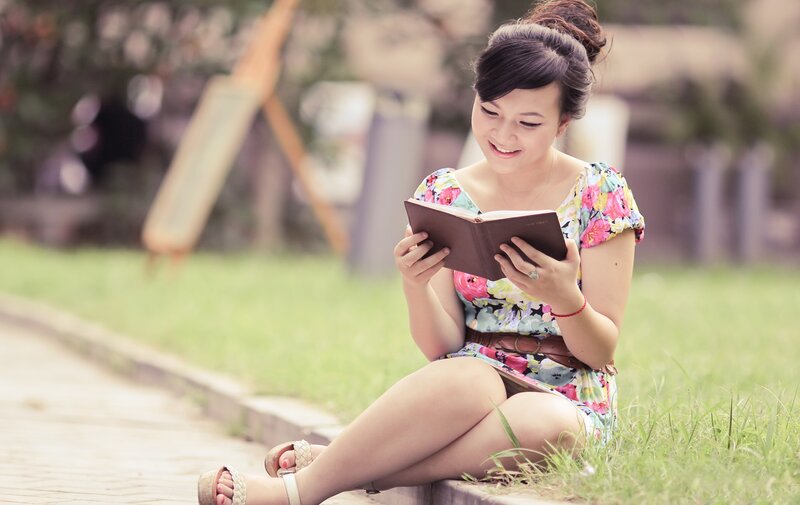 woman reading book outdoors