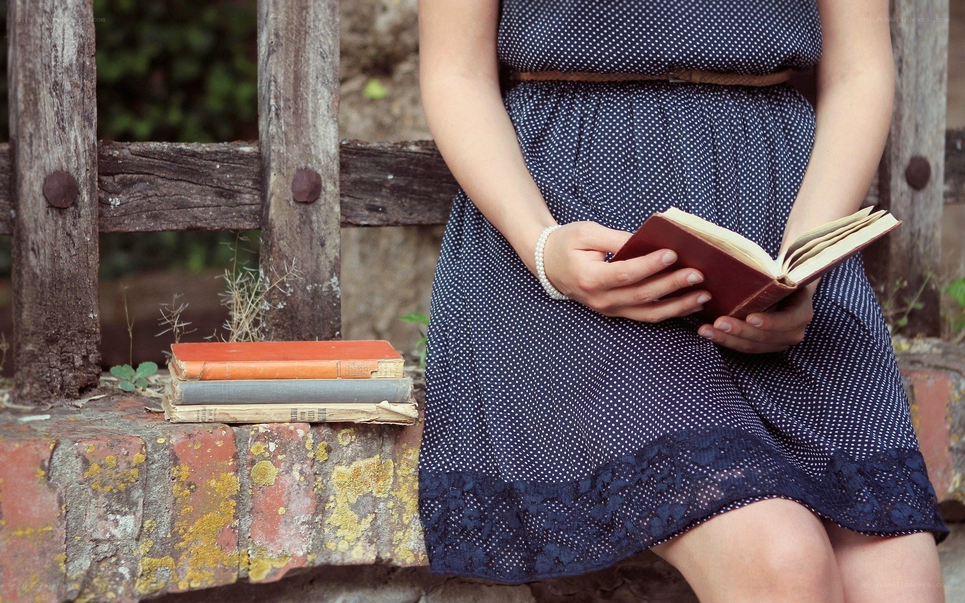 woman reading book outdoors