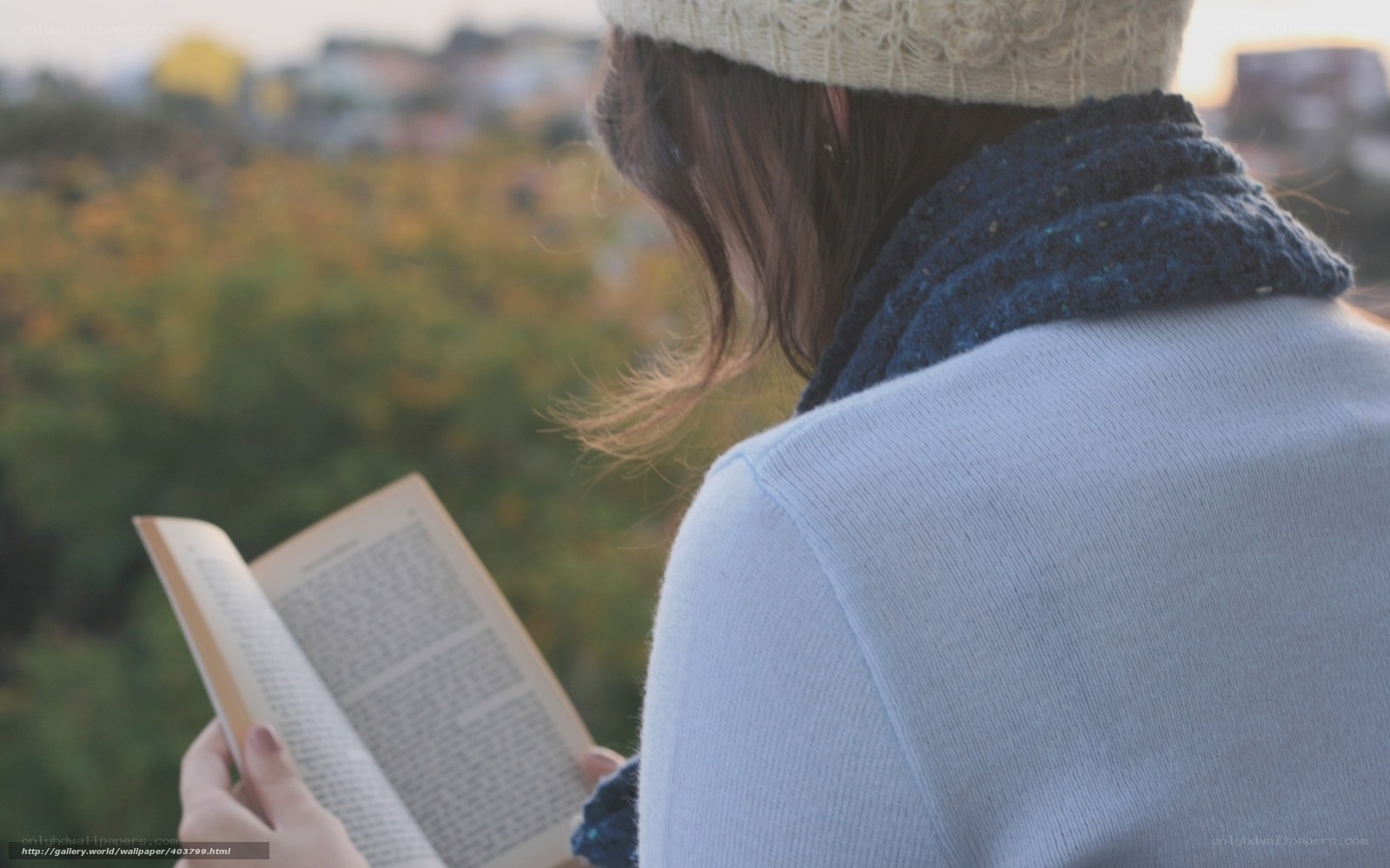 woman reading book outdoors