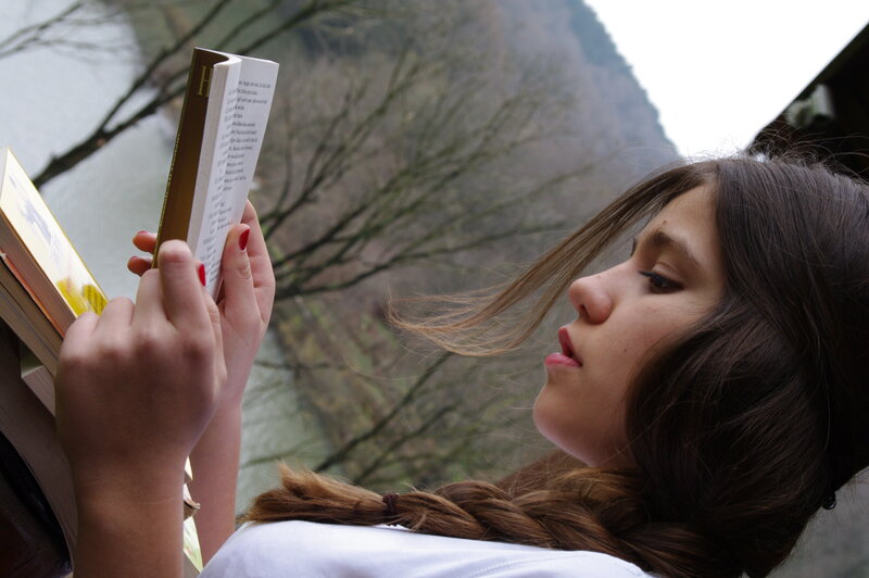 woman reading book outdoors