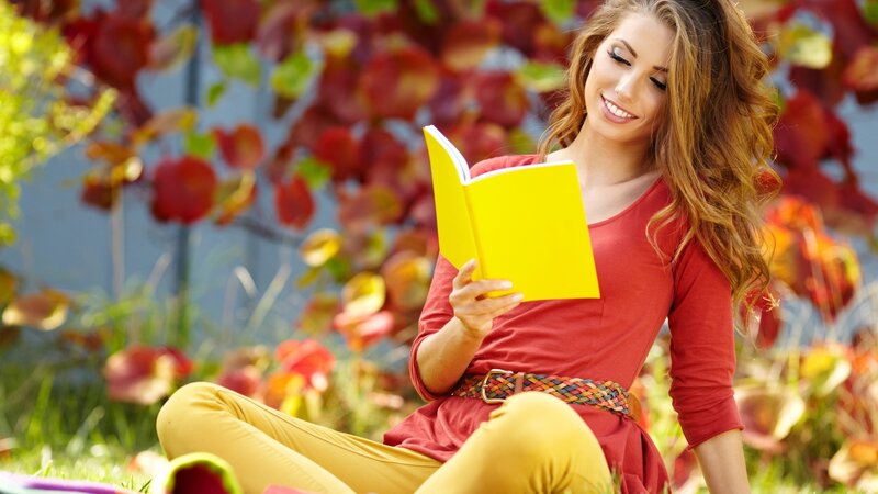 Woman reading book outdoors