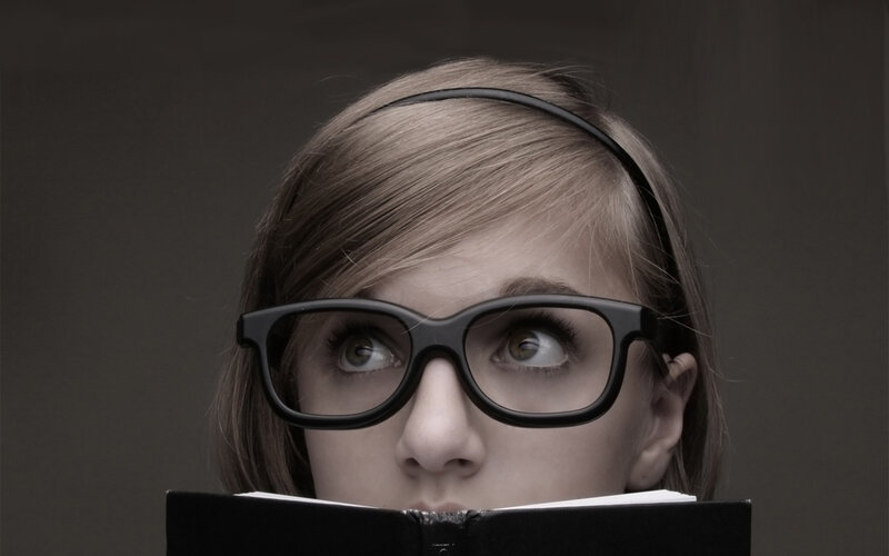 woman reading book with glasses