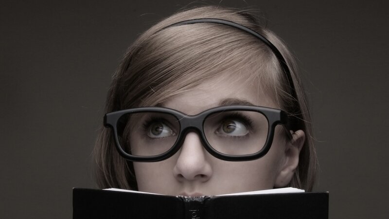 woman reading book with glasses