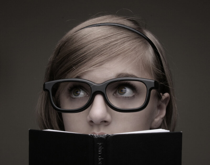 woman reading book with glasses