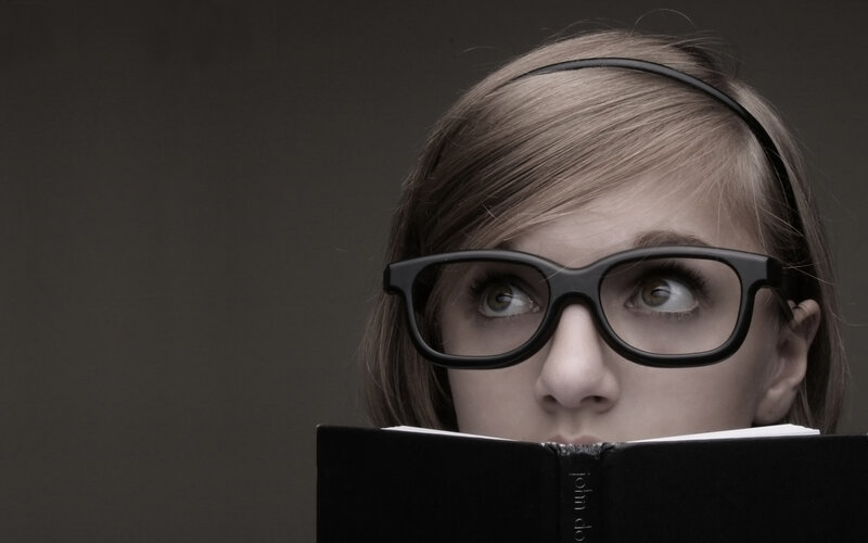 woman reading book with glasses