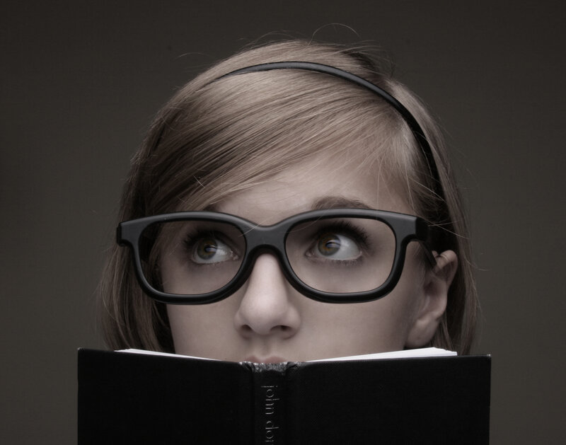 woman reading book with glasses