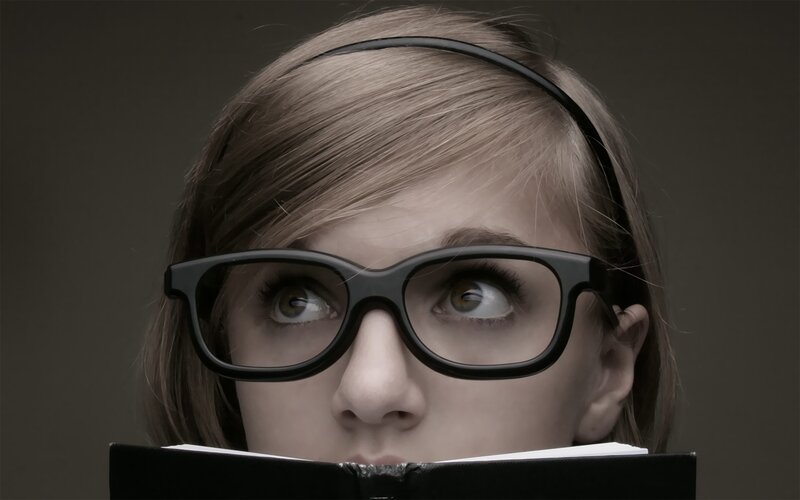 woman reading book with glasses