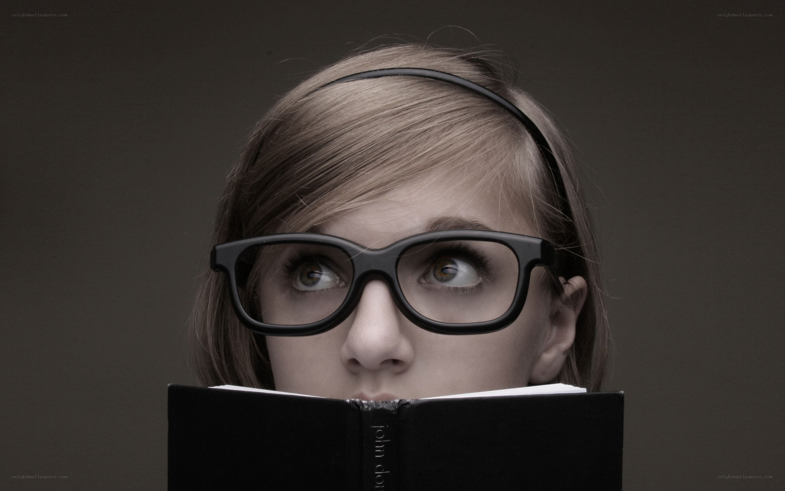 woman reading book with glasses