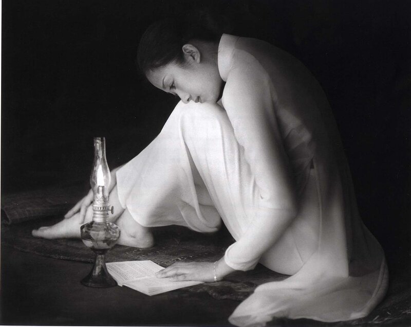 Woman Reading by Lamp