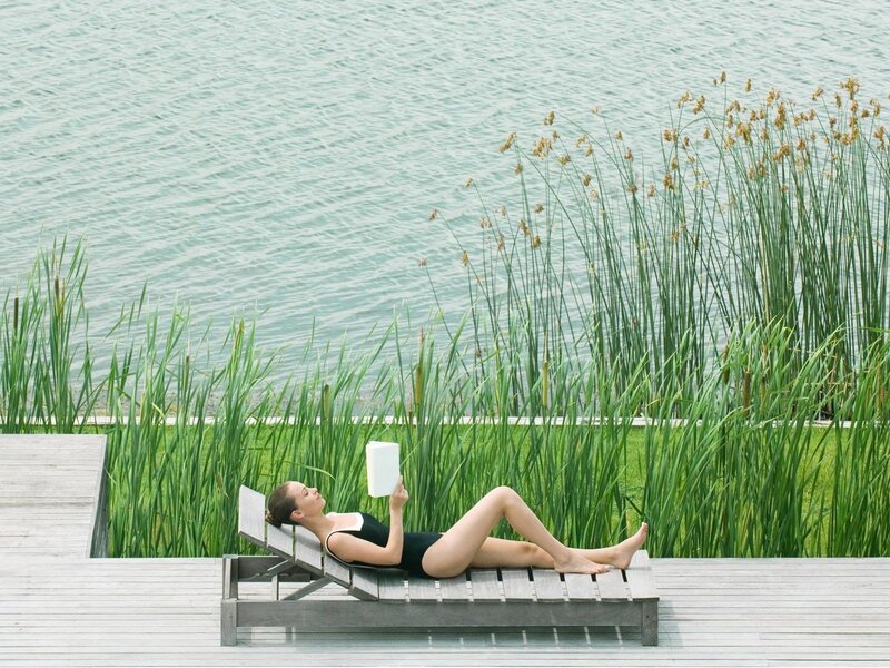 Woman reading by the lake