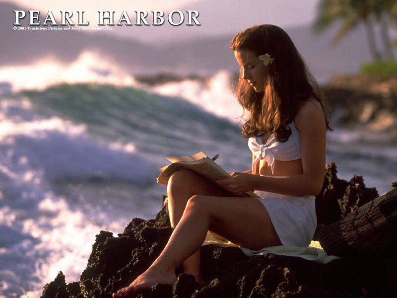 woman reading by the ocean