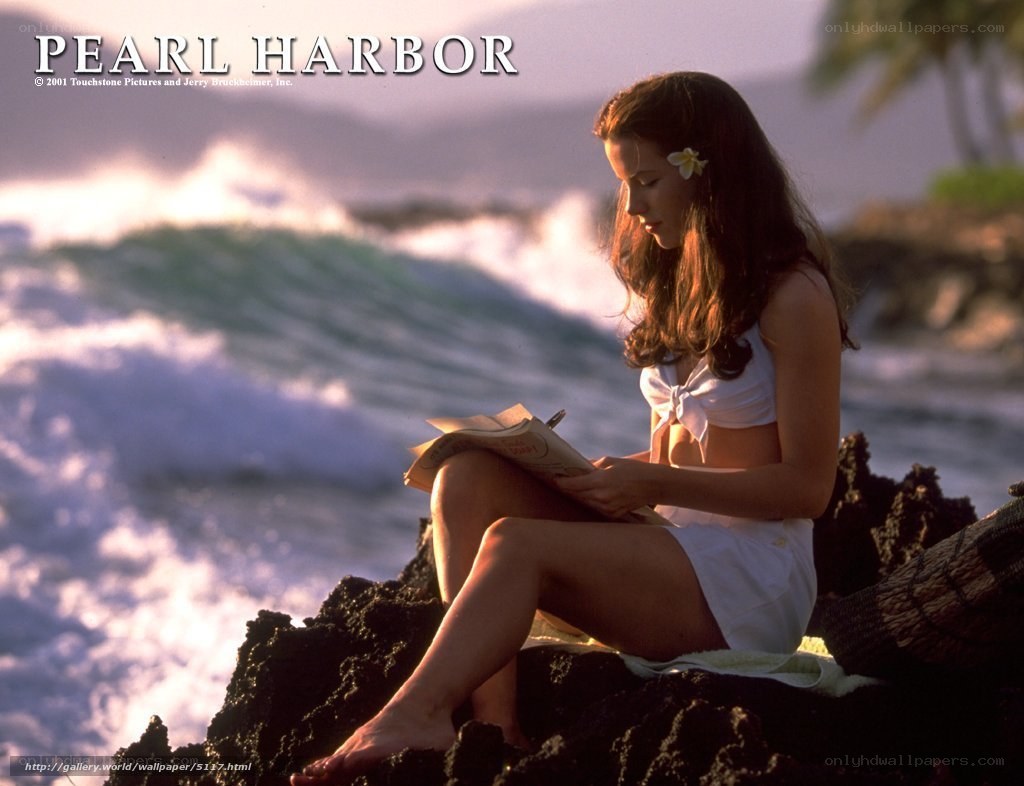 woman reading by the ocean