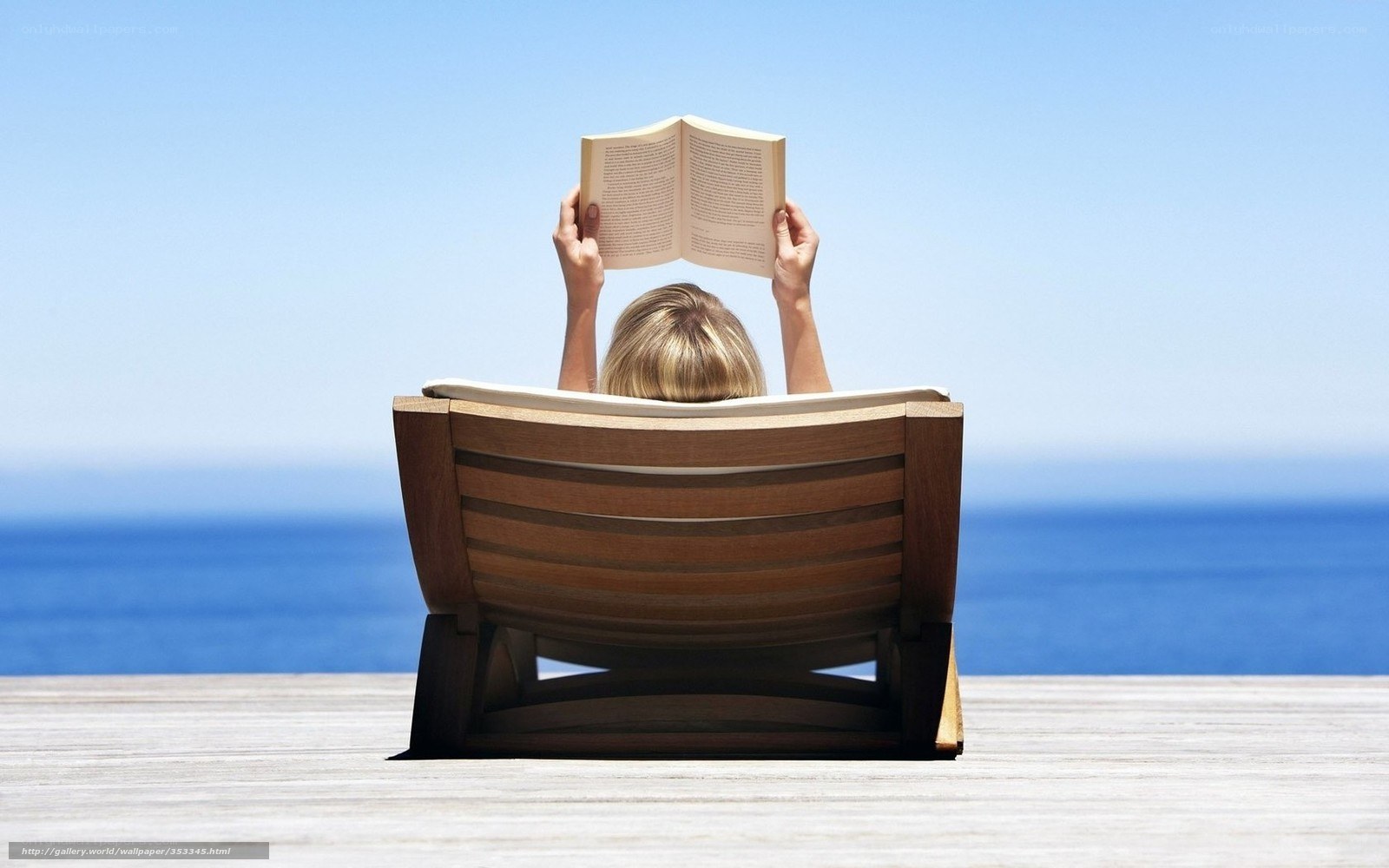 Woman reading by the sea