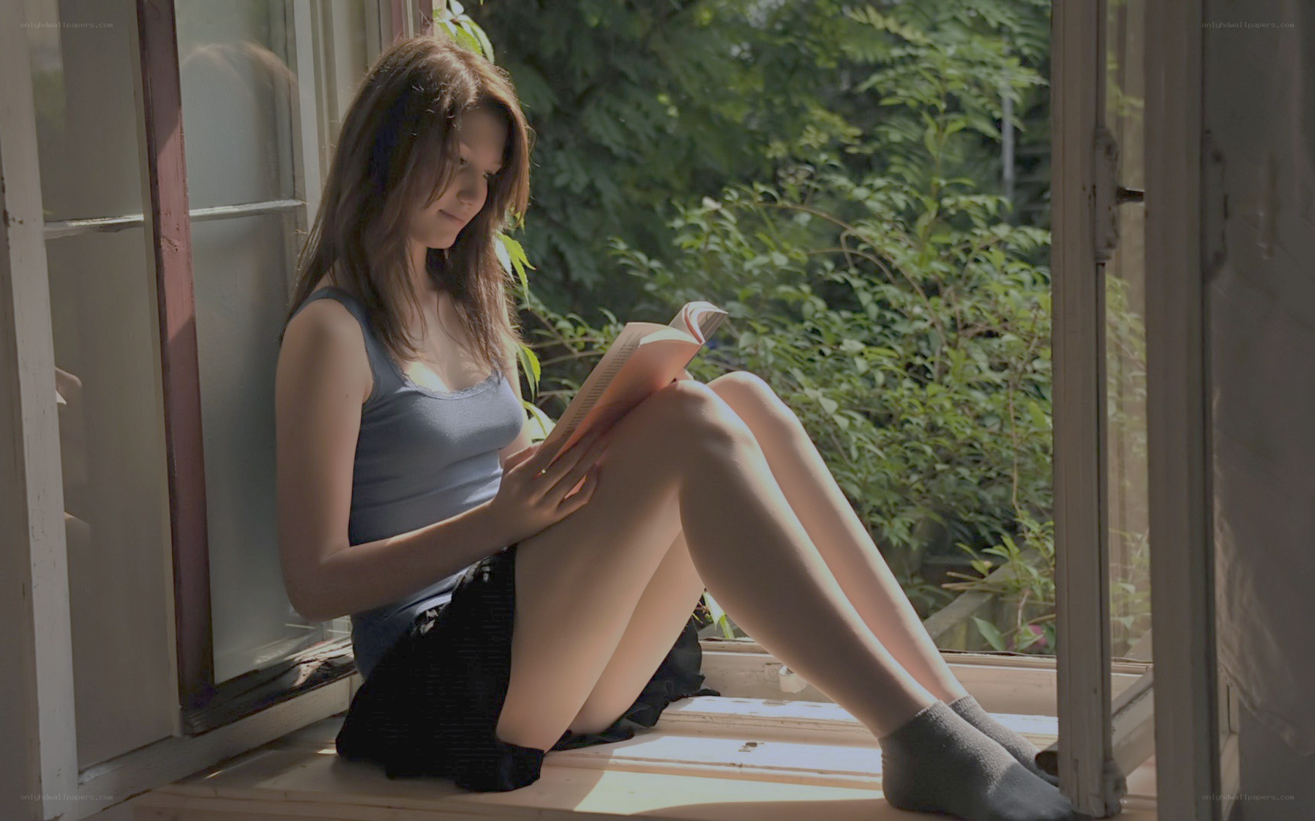 woman reading by the window