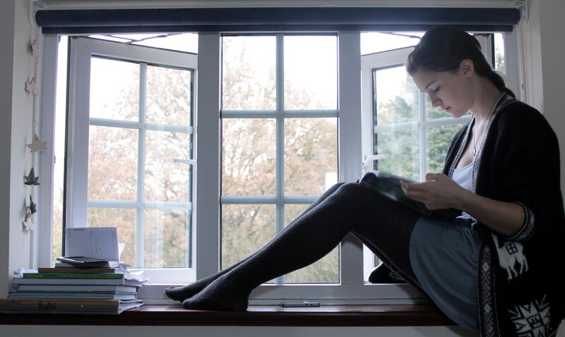 woman reading by the window