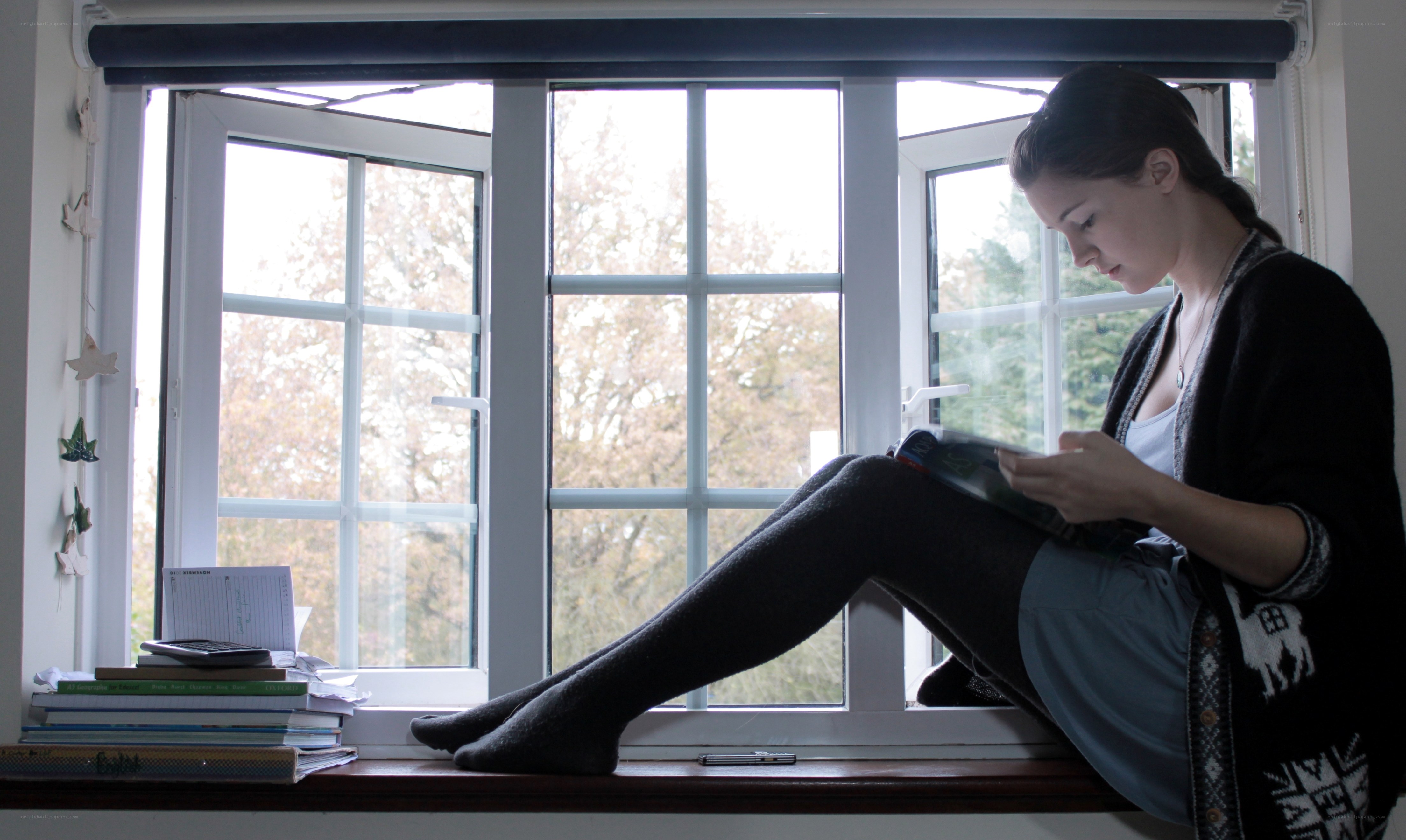 woman reading by the window