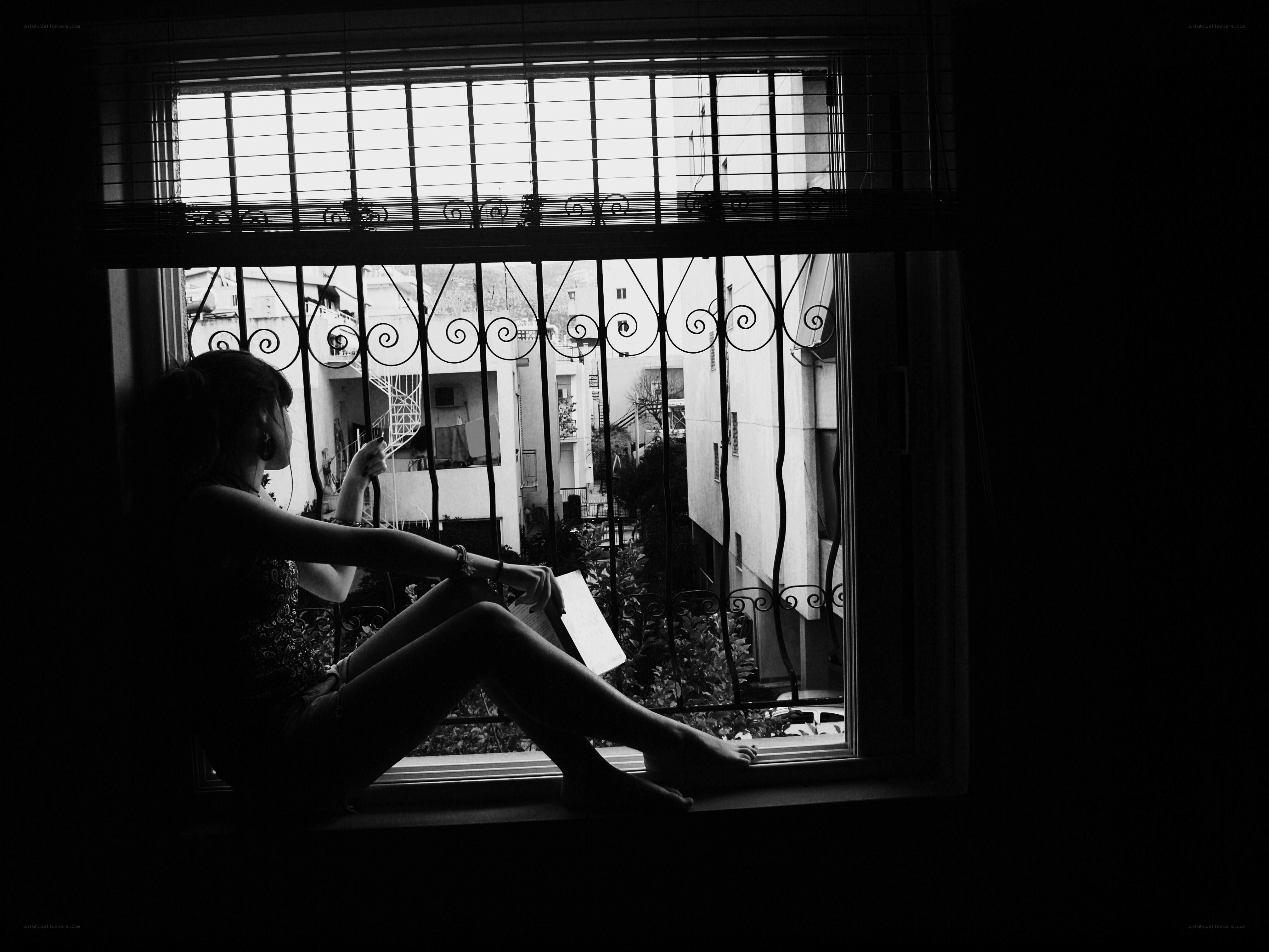 woman reading by window