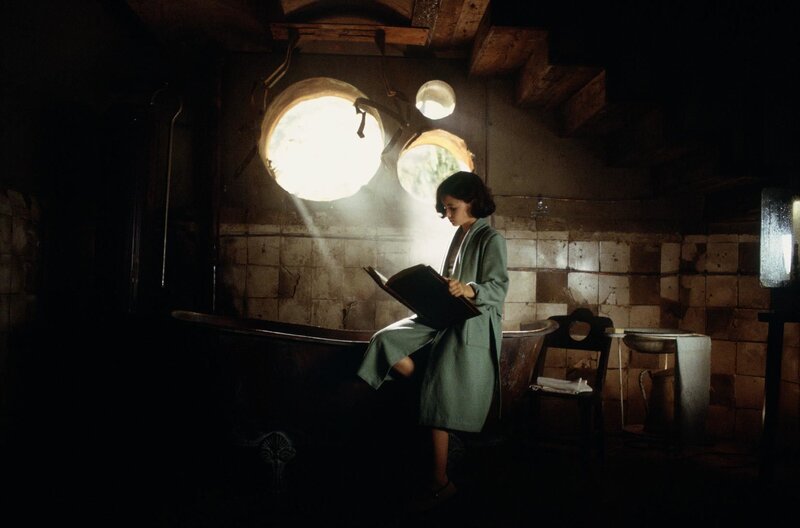 woman reading by window light