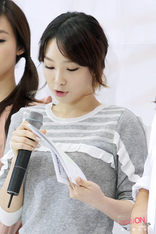 woman reading from paper with microphone