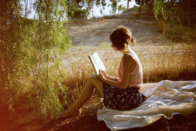woman reading in a field
