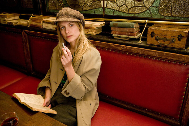 Woman reading in a vintage booth