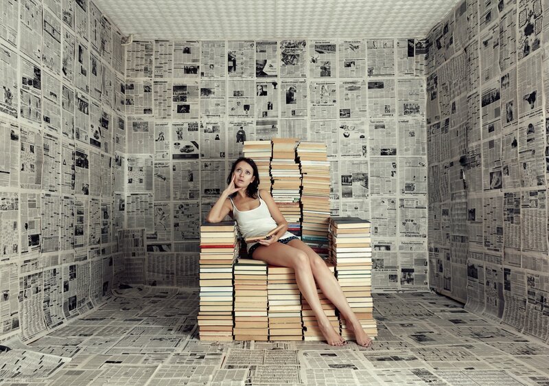 woman reading in book room
