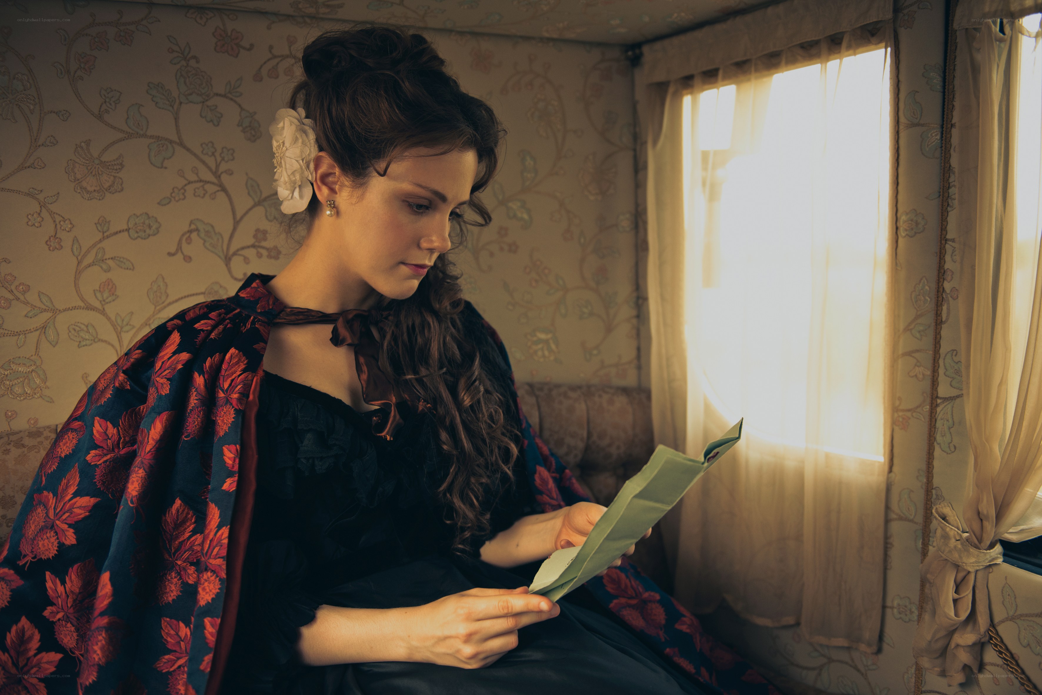 woman reading letter in vintage room