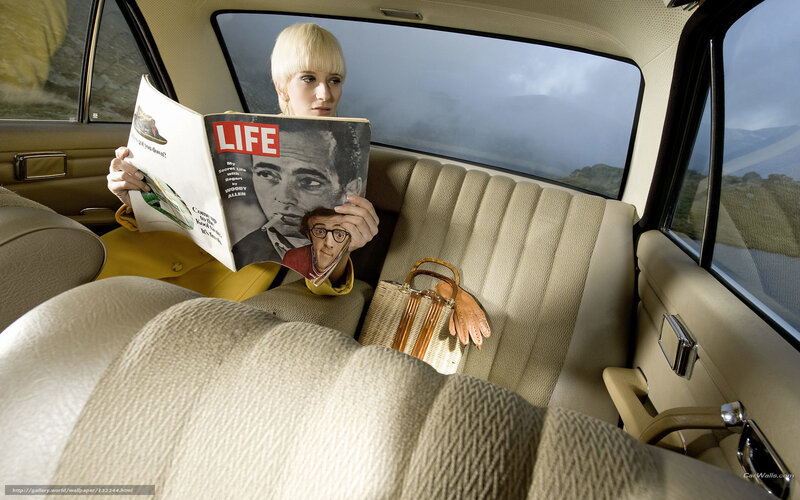 Woman reading magazine in car
