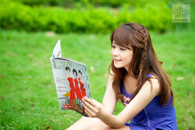 Woman reading magazine in park