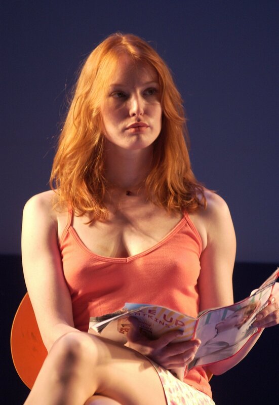 Woman reading magazine on stage