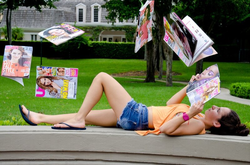 Woman reading magazines outdoors